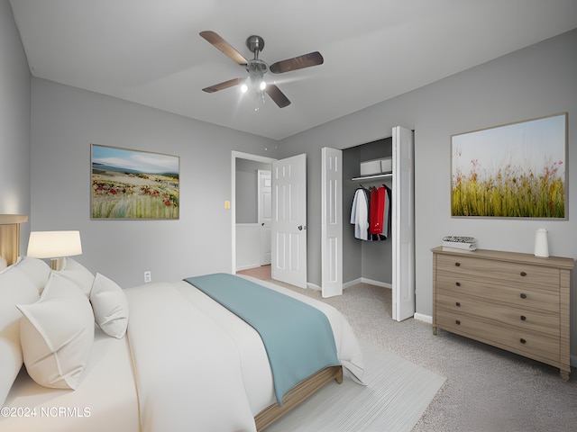 carpeted bedroom featuring ceiling fan and a closet