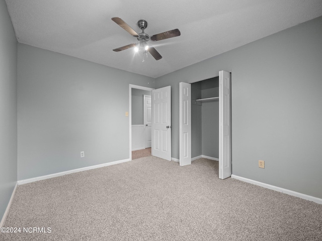 unfurnished bedroom with carpet, a closet, and ceiling fan