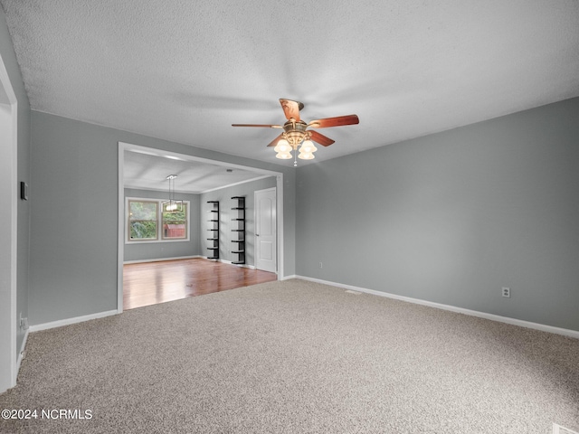 empty room featuring wood-type flooring, a textured ceiling, and ceiling fan