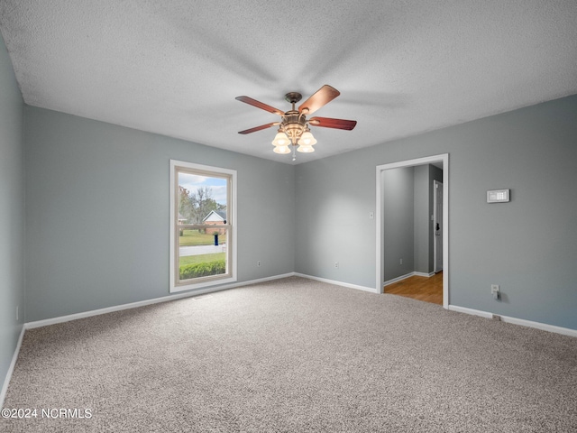 empty room with carpet, a textured ceiling, and ceiling fan