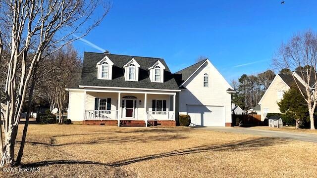 cape cod home featuring a porch and a front yard