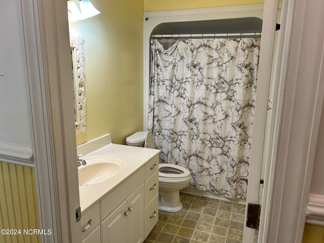 bathroom with tile patterned flooring, toilet, and vanity