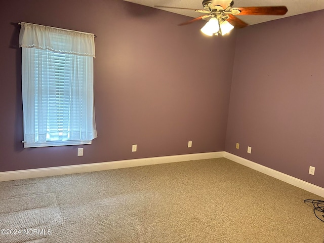 empty room featuring carpet floors and ceiling fan