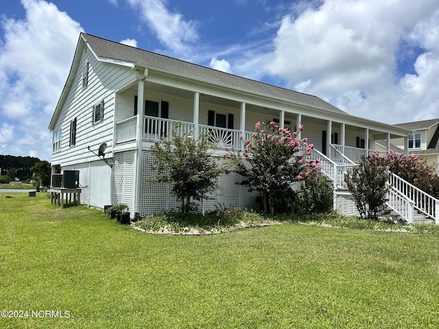 view of front of home with a porch, central AC, a front lawn, and stairs