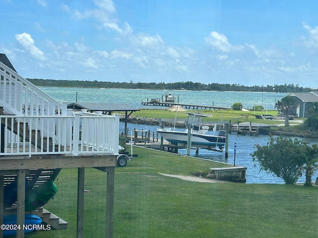 dock area with a water view and a lawn