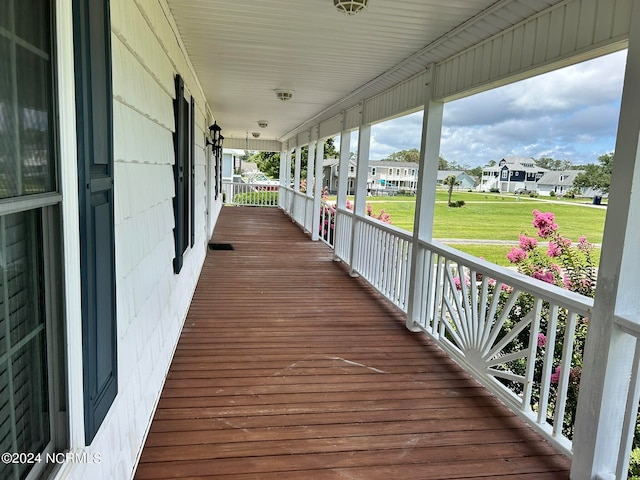 wooden terrace with a lawn