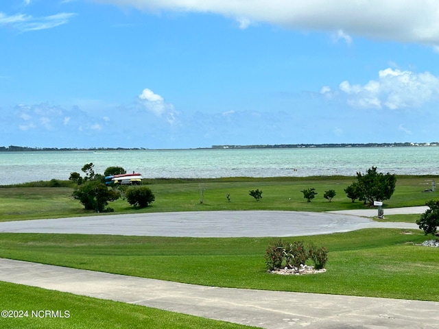 view of community with a water view and a yard