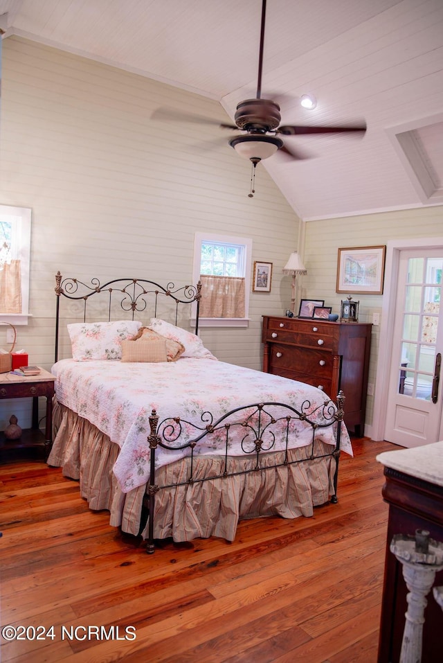 bedroom featuring ceiling fan, hardwood / wood-style floors, and vaulted ceiling