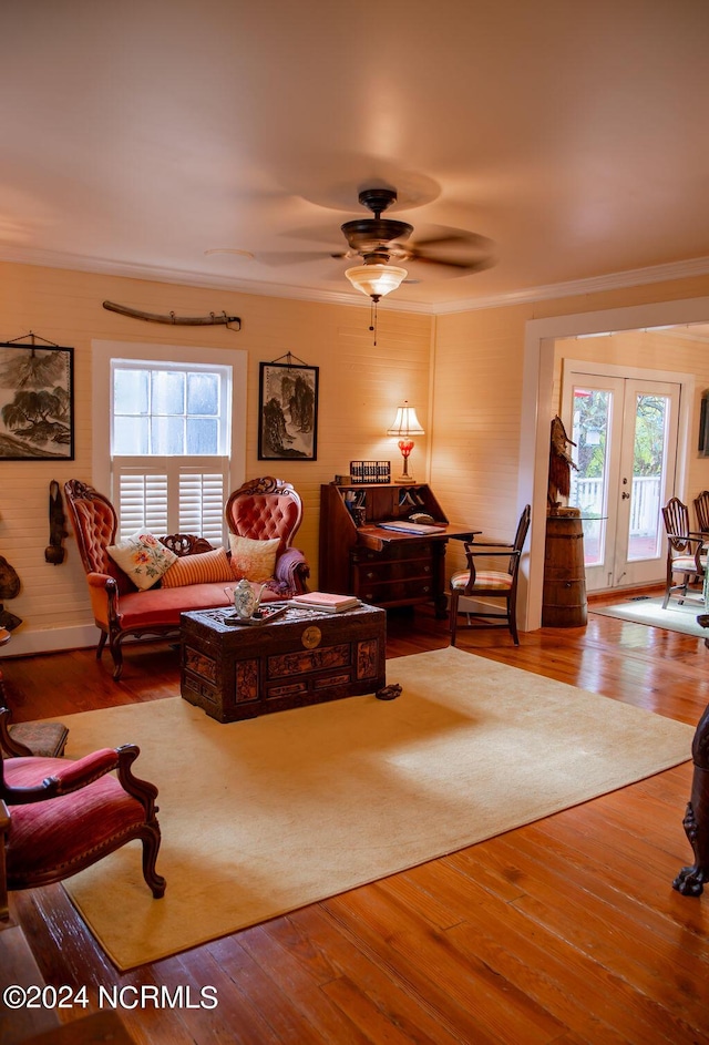 living room featuring hardwood / wood-style flooring, ceiling fan, french doors, and ornamental molding