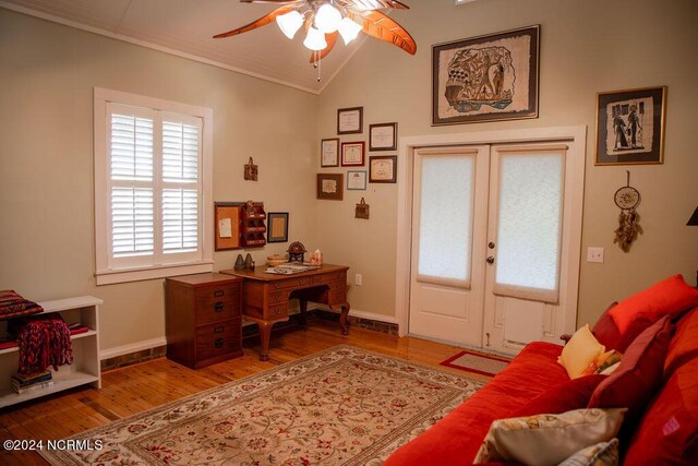 interior space featuring vaulted ceiling, ceiling fan, ornamental molding, and wood-type flooring