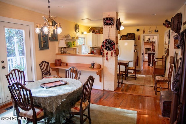 dining room featuring hardwood / wood-style flooring and a notable chandelier