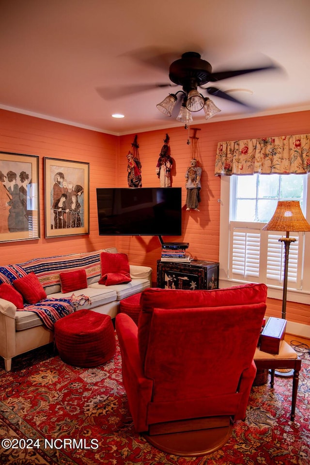 living room with ceiling fan and crown molding