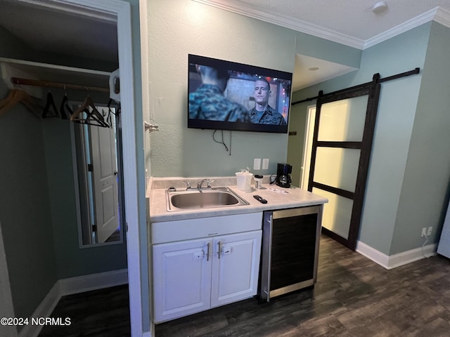 kitchen with sink, white cabinets, beverage cooler, dark hardwood / wood-style flooring, and a barn door