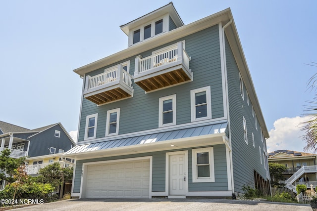 view of front of property with a balcony and a garage