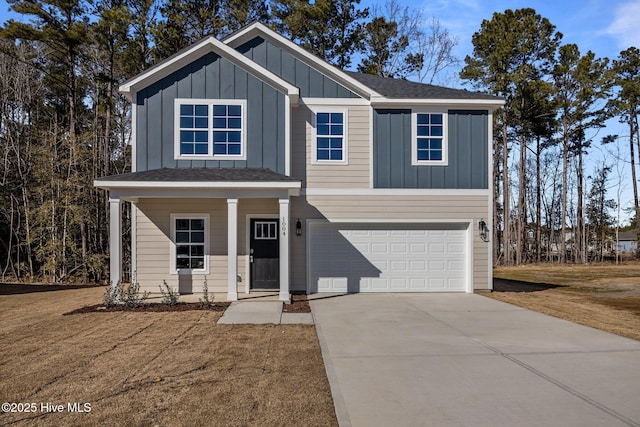 view of front of house featuring a garage, covered porch, and a front lawn