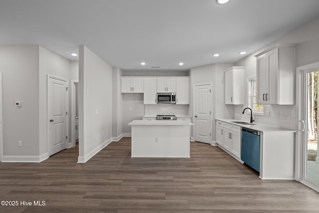 kitchen with stainless steel appliances, a center island, and white cabinets