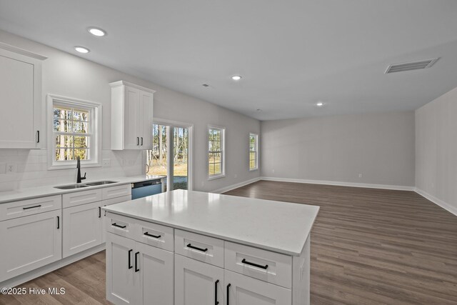 kitchen featuring white cabinetry, dishwasher, sink, and dark hardwood / wood-style flooring