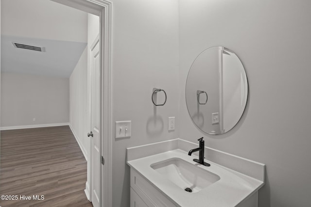 bathroom featuring vanity and hardwood / wood-style floors