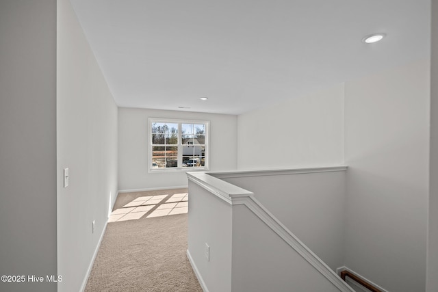 hall featuring light colored carpet