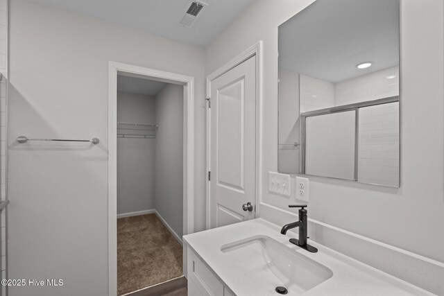 bathroom with vanity and walk in shower