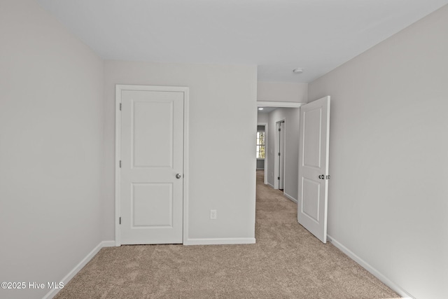 unfurnished bedroom with light carpet