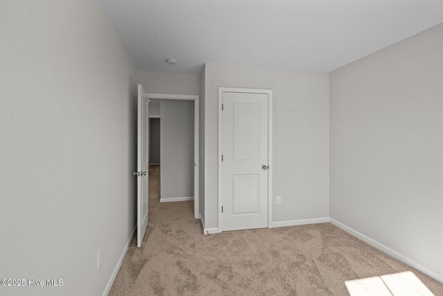 unfurnished bedroom with light carpet