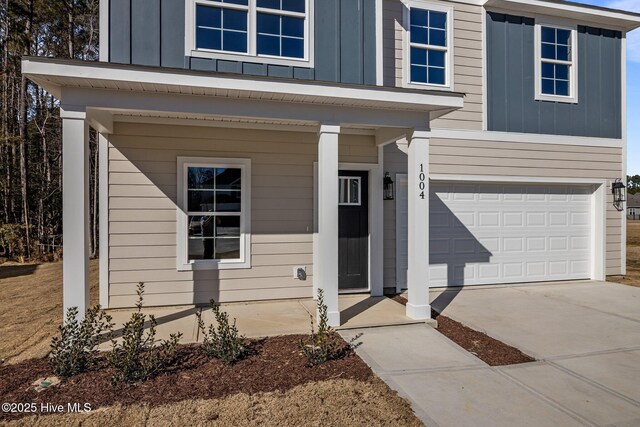 doorway to property featuring a garage and a porch