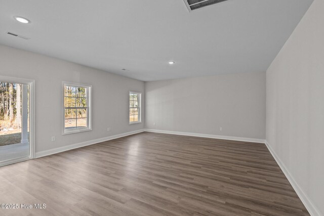 empty room with hardwood / wood-style flooring
