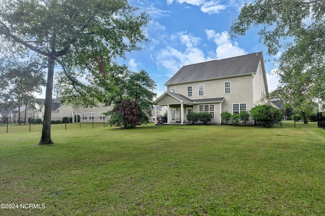 rear view of house with a yard