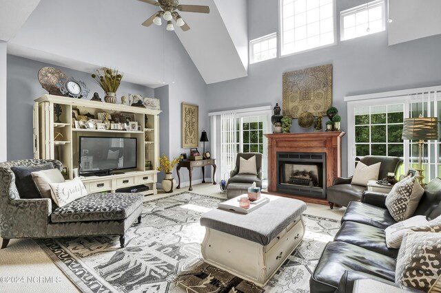 living room with high vaulted ceiling and ceiling fan