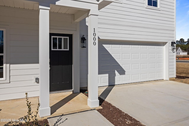 doorway to property with a garage