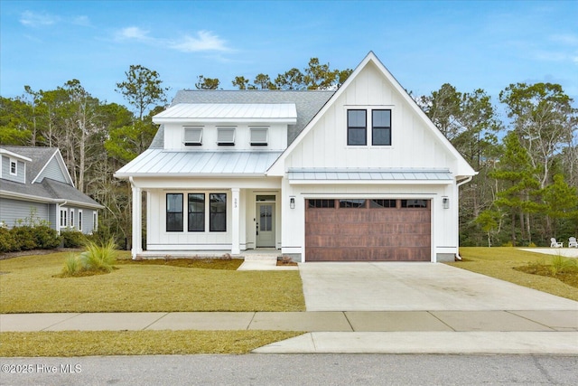 modern inspired farmhouse featuring a garage and a front lawn