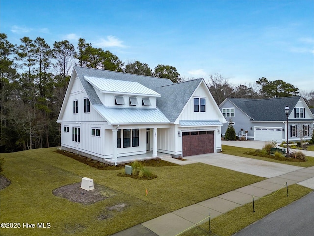 modern farmhouse style home with a garage and a front lawn