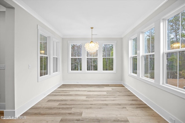 unfurnished sunroom featuring a chandelier