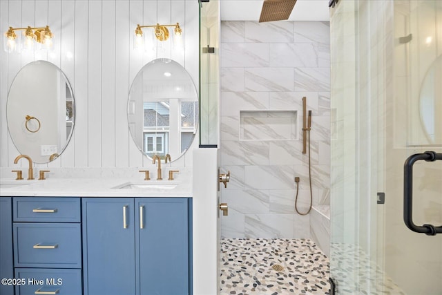 bathroom featuring walk in shower and vanity