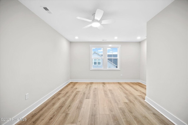 empty room with light hardwood / wood-style flooring and ceiling fan