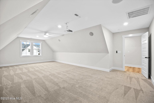 bonus room featuring lofted ceiling and light colored carpet