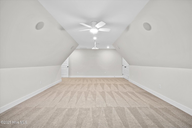 bonus room featuring lofted ceiling, light carpet, and ceiling fan