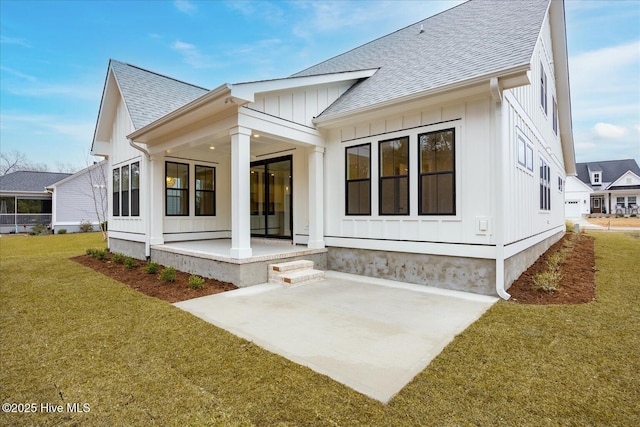 rear view of house featuring a patio area and a lawn