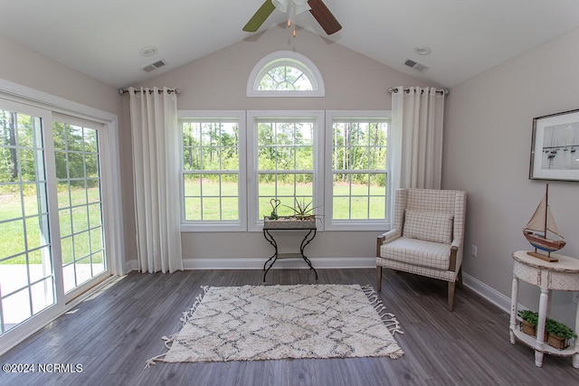 sitting room featuring dark wood-type flooring, vaulted ceiling, and plenty of natural light