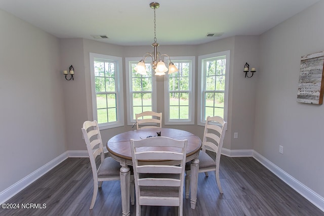 dining room with an inviting chandelier and dark hardwood / wood-style flooring