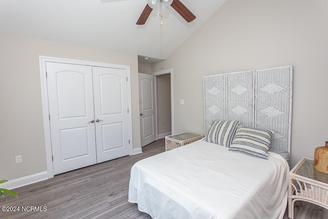 bedroom featuring a closet, wood-type flooring, ceiling fan, and high vaulted ceiling