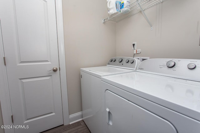 laundry room featuring separate washer and dryer and wood-type flooring