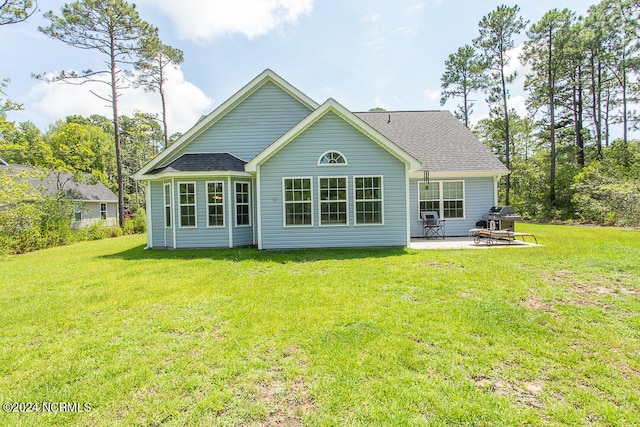 back of house with a patio and a yard