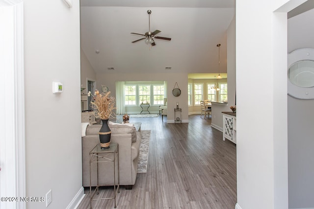 living room featuring ceiling fan, hardwood / wood-style flooring, and high vaulted ceiling