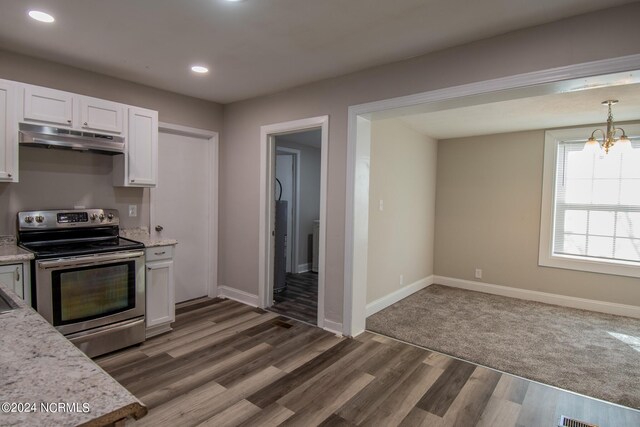 kitchen with stainless steel electric range oven, white cabinets, decorative light fixtures, a chandelier, and dark hardwood / wood-style floors