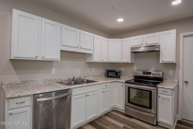 kitchen featuring white cabinetry, wood-type flooring, stainless steel appliances, and sink