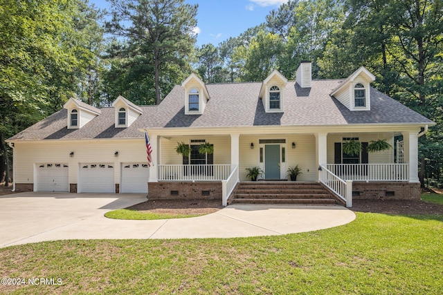 new england style home featuring a garage, a front yard, and a porch