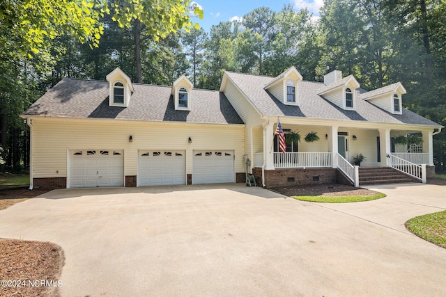 cape cod home featuring a garage and a porch