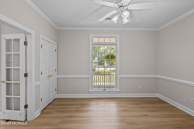 spare room with ceiling fan, ornamental molding, and light wood-type flooring